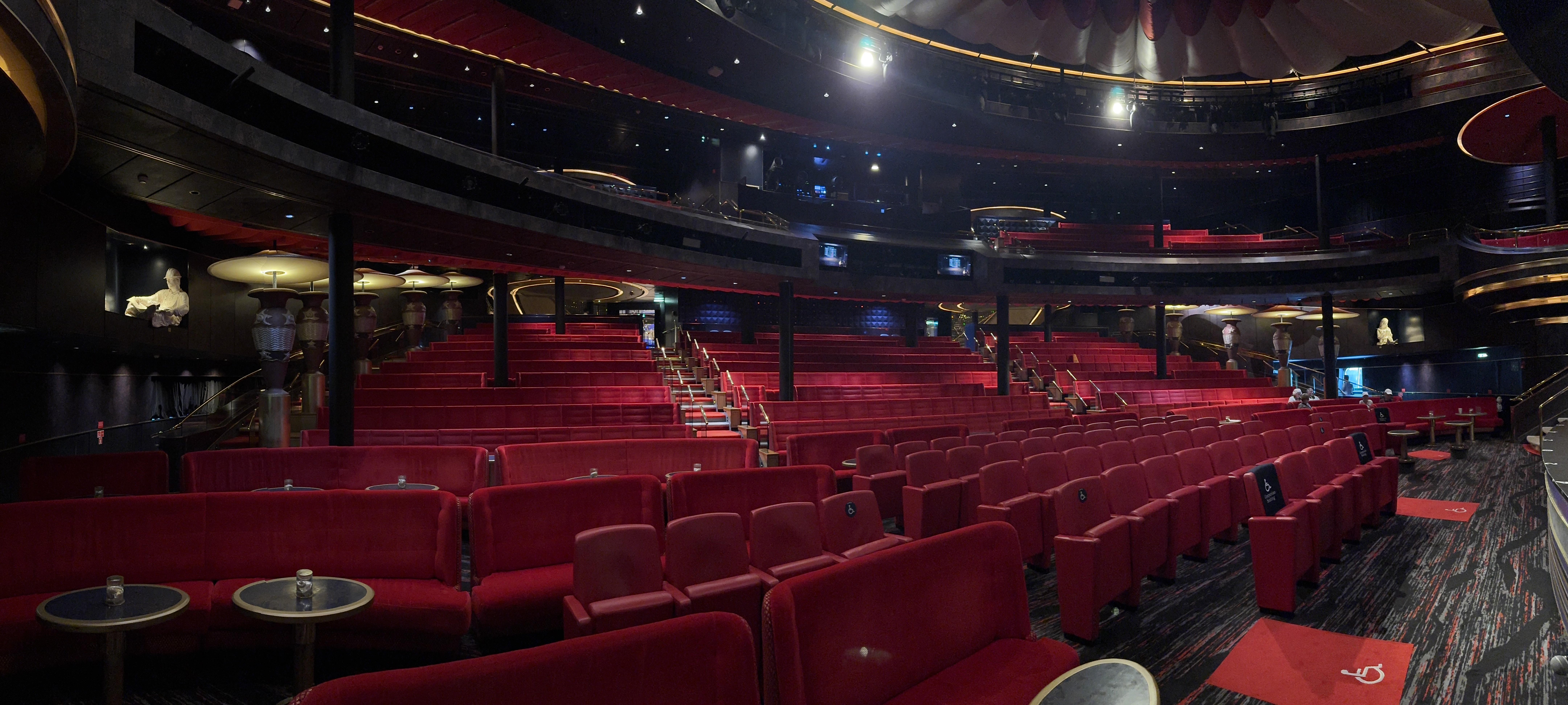 Elegant theatre venue with red velvet seating and dramatic lighting
