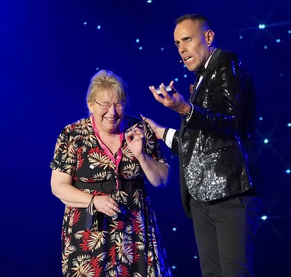 Johnny Balance engaging with an audience member during a live performance